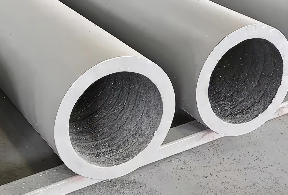 Overlay wear pipe with hardfaced bore